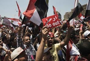Egypt's Tahrir Square protesters show President Mohamed Morsi the 'red card'