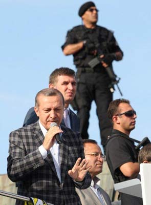 Turkey PM Recep Erdogan climbs on bus, slams protesters