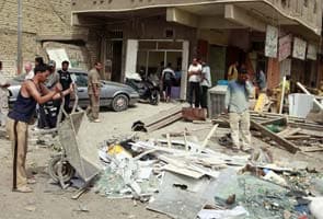 Bombs hit Iraq funeral and football stadium, killing 22