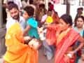 Panicked parents carry children poisoned by mid-day meals out of hospital