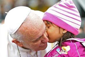 Pope Francis halts motorcade in Brazil to kiss babies