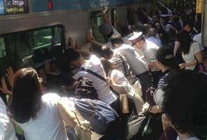 Pushy train passengers in Japan free woman stuck in gap