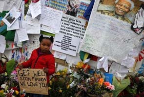 Nelson Mandela marks two months in hospital, South Africans offer prayers