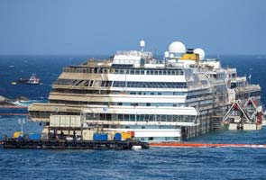 Costa Concordia hauled upright off Italy coast