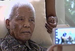 Nelson Mandela 'sitting up', 'much better', says his grandson