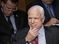 Poker face: John McCain plays phone game at Syria debate
