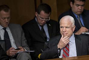 Poker face: John McCain plays phone game at Syria debate