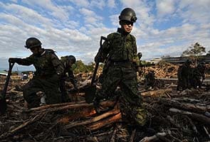 Japan rescuers search mudslide for typhoon survivors