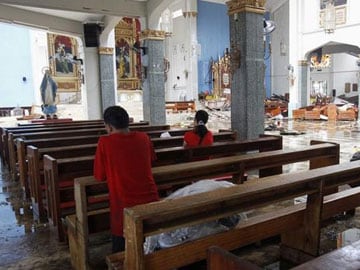 Toppled Philippine church cross overlooks typhoon's destruction