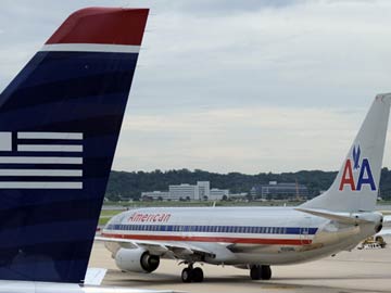 American, US Airways see merger closing on December 9