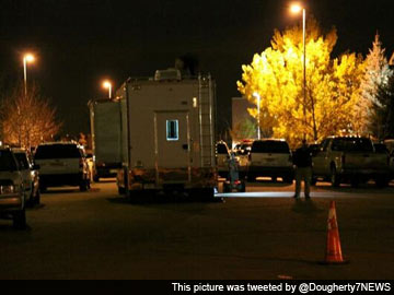 Denver police say two armed men inside empty school