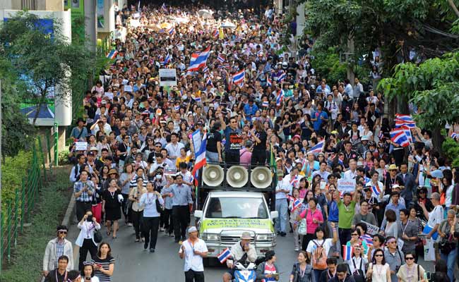 Defiant Thai protesters target telecom firms