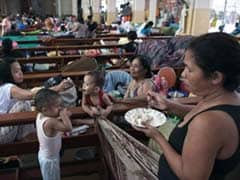 Philippine typhoon toll rises to record 5,209: official