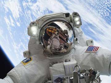 NASA astronaut takes selfie from space with Earth behind him