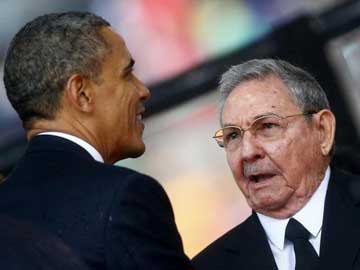 Barack Obama, Raul Castro shake hands as world says farewell to Nelson Mandela