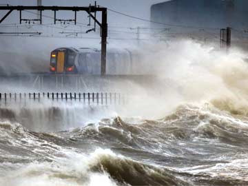High winds, waves and tides lash Britain's coast
