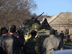 Armoured vehicles break into Ukraine base in Crimea, shots fired