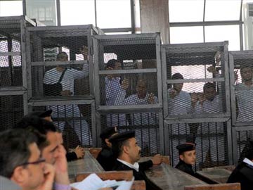 At trial in Egypt court, Al-Jazeera journalists appeared in caged dock 