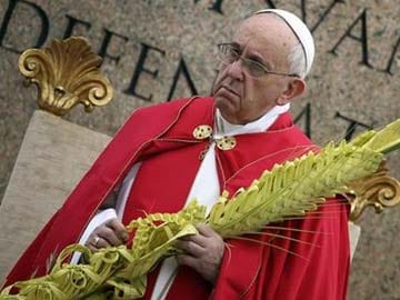 Sombre, tired-looking Pope presides at Palm Sunday services