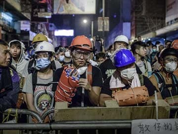 Hong Kong Protesters Add Helmets to Their Umbrellas