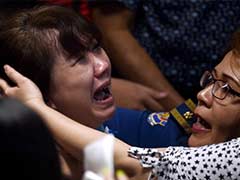 As AirAsia Passengers' Bodies are Found, Grieving Relatives Faint