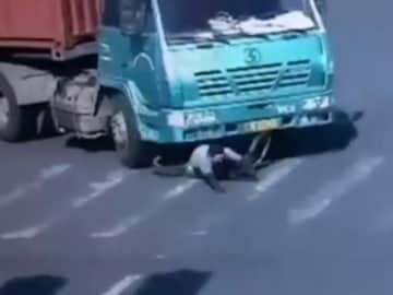 Caught on Camera: Man Gets Run Over by 14-Wheel Truck, Sits Right Back Up