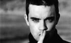 Robbie Williams warns fans of online impostor
