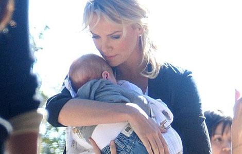 Charlize Theron's son is "permanently attached" to her
