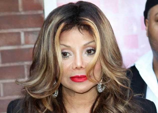  Latoya Jackson is protected by bodyguards as she leaves the