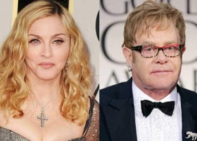 Madonna has "forgiven" Sir Elton John for calling her a "fairground stripper"