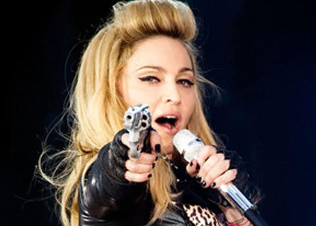 Fans walk out of Madonna concert after she brandishes fake gun 