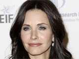 Courteney Cox cuts short vacation after breaking her wrist