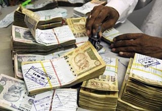 Rupee ends near key 56-level after Fitch warning, RBI inaction