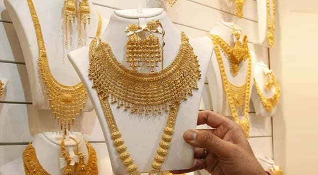 Gold edges lower, traders watch monsoon