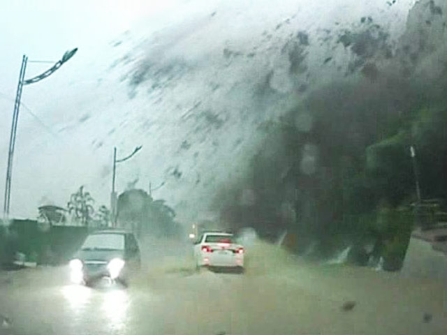Dramatic moment when part of a mountain crashed next to a car
