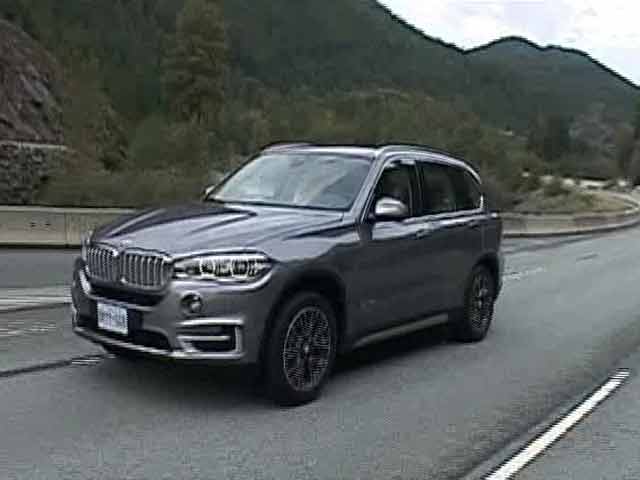 Car BMW X5 Third Generation F15 Driving in City with Motion Blur