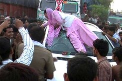 Young Agra Woman's Protest on Top of Mercedes Goes Viral Young Agra Woman's Protest on Top of Mercedes Goes Viral