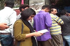 With Fat Books And Empty Pockets, Students In Exam Time Mug Up In ATM Queues With Fat Books And Empty Pockets, Students In Exam Time Mug Up In ATM Queues